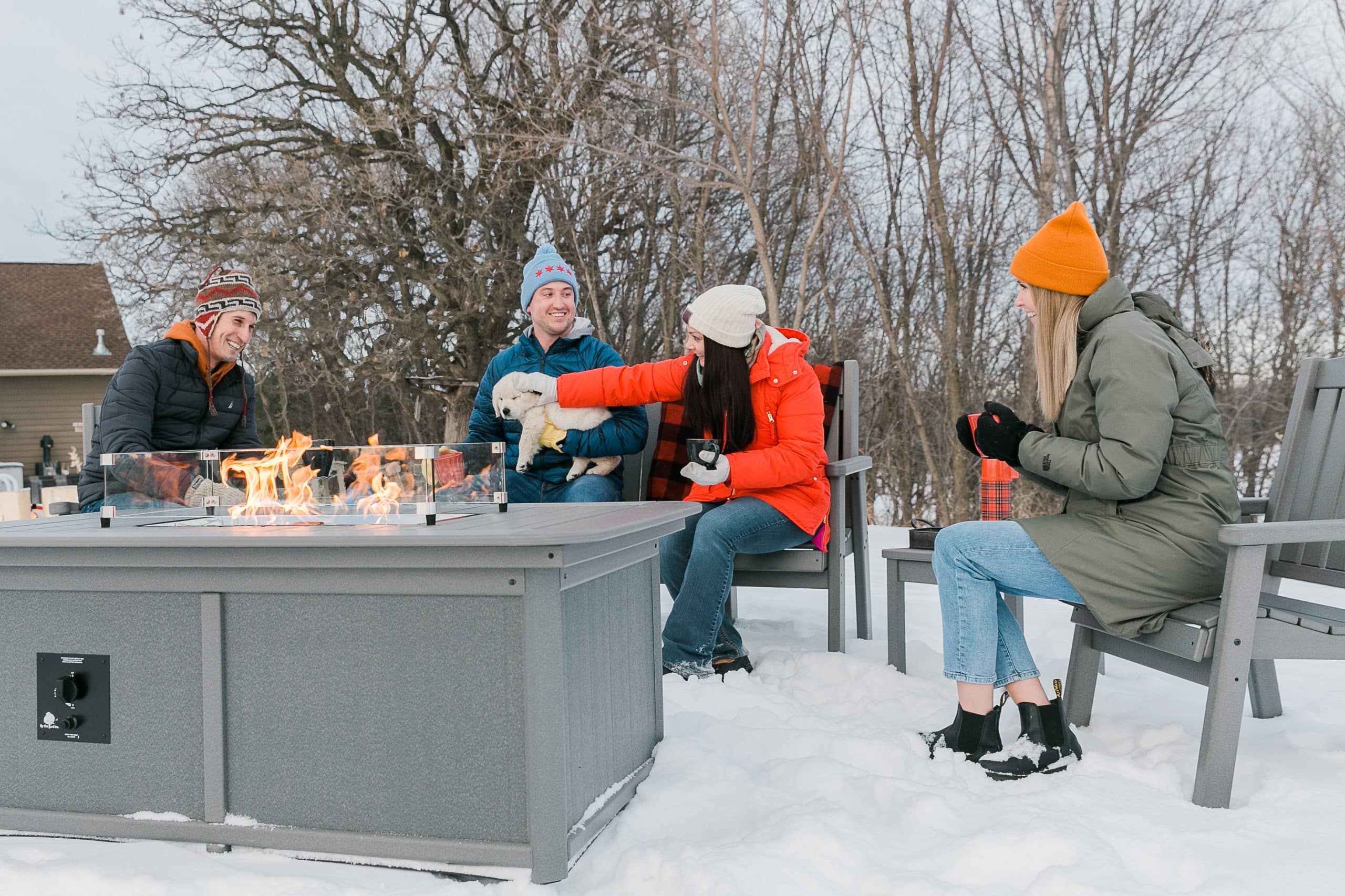 people sitting around a By the Yard fire table