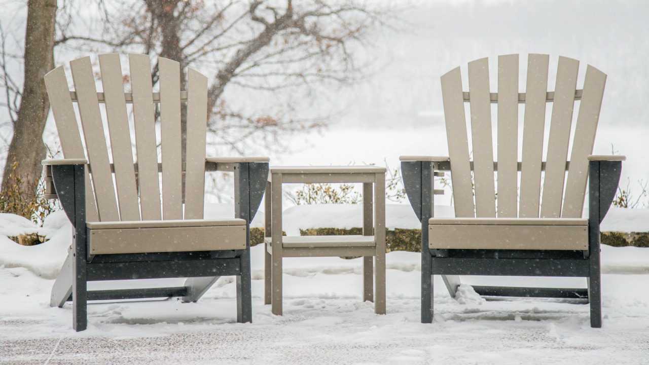 two hdpe adirondack chairs in the snow