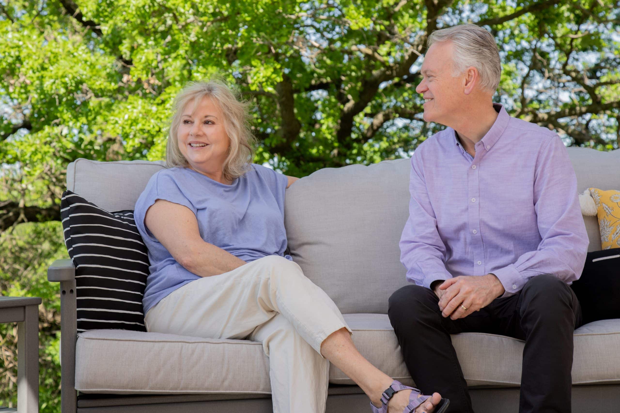 elderly couple sitting in a By the Yard deep seat sofa