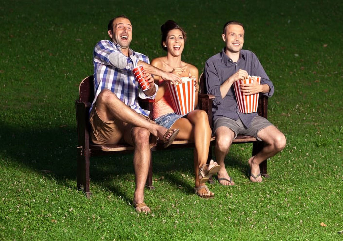 friends on a bench eating popcorn