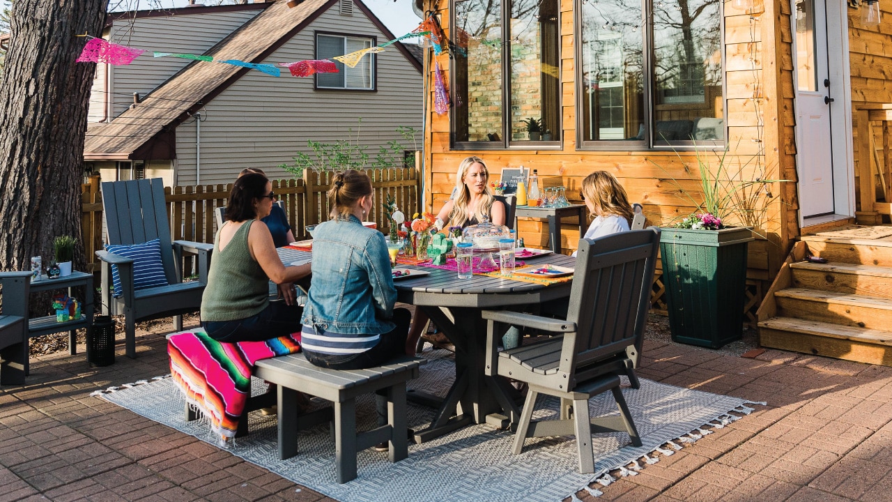 friends sitting around a By the Yard outdoor table